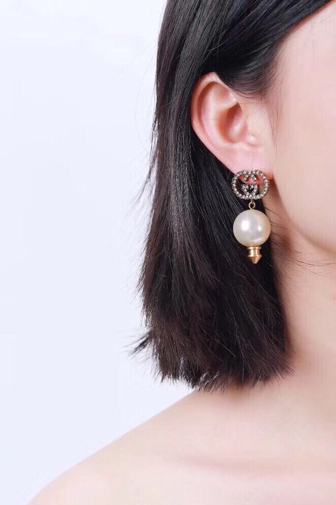 Martin Graham stud earrings in polished metal-tone – front product view
