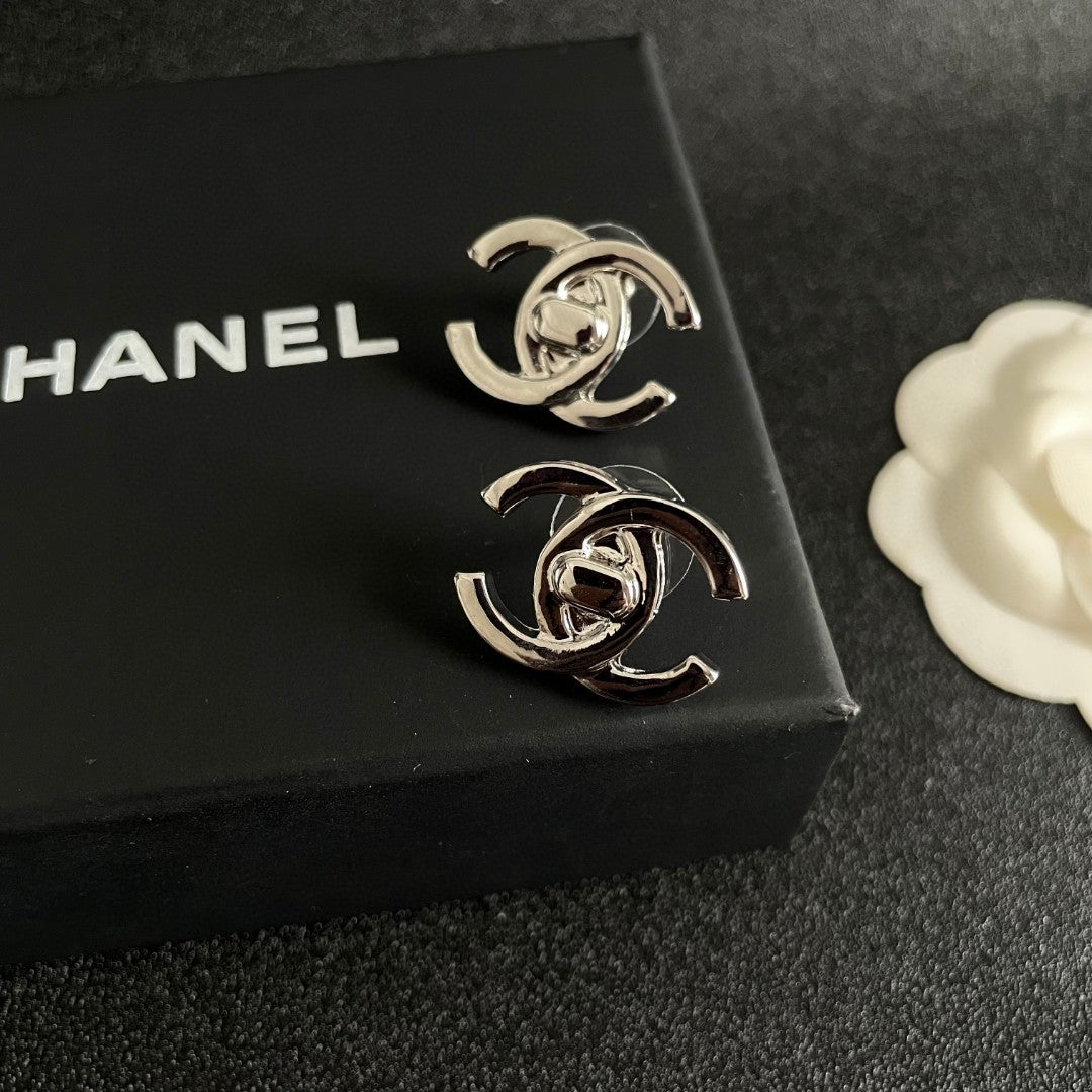 Martin Graham stud earrings in polished metal-tone – detail view