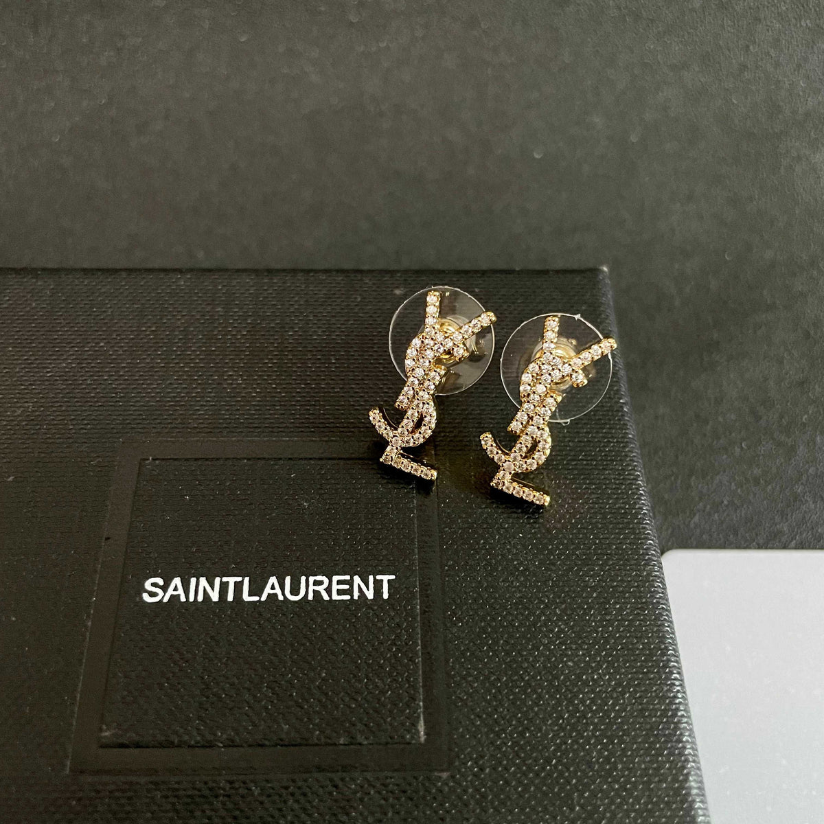 Martin Graham stud earrings in polished metal-tone – detail view