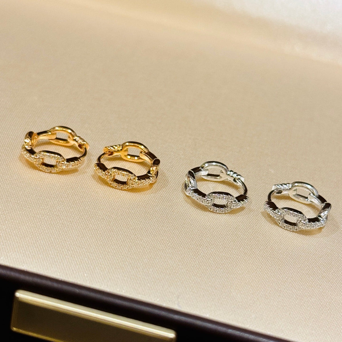 Martin Graham stud earrings in polished metal-tone – detail view