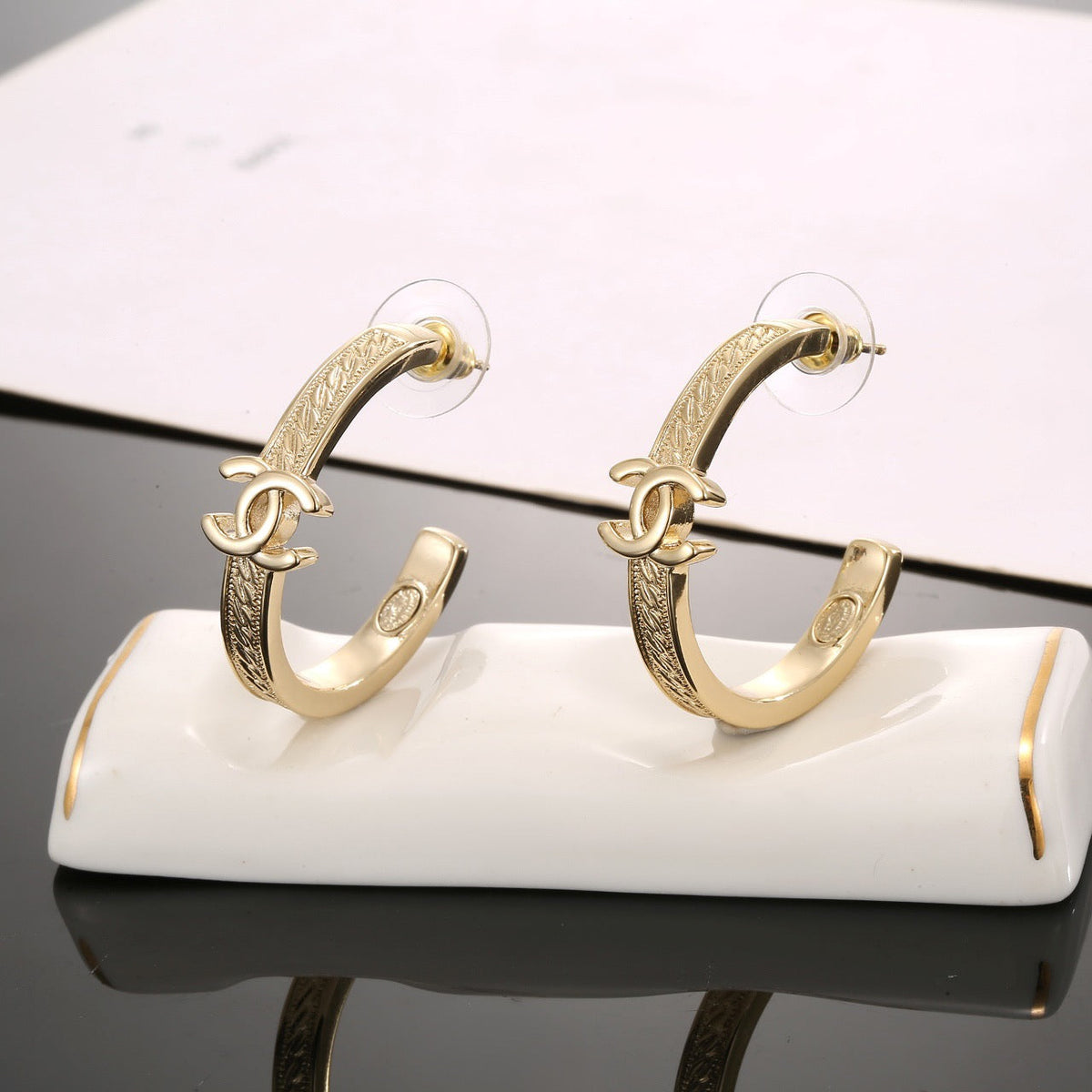 Martin Graham stud earrings in polished metal-tone – styled product view