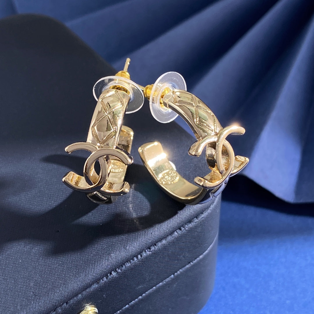 Martin Graham stud earrings in polished metal-tone – detail view