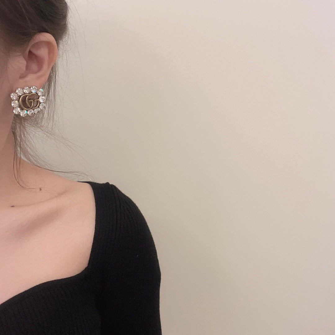 Martin Graham stud earrings in polished metal-tone – side detail