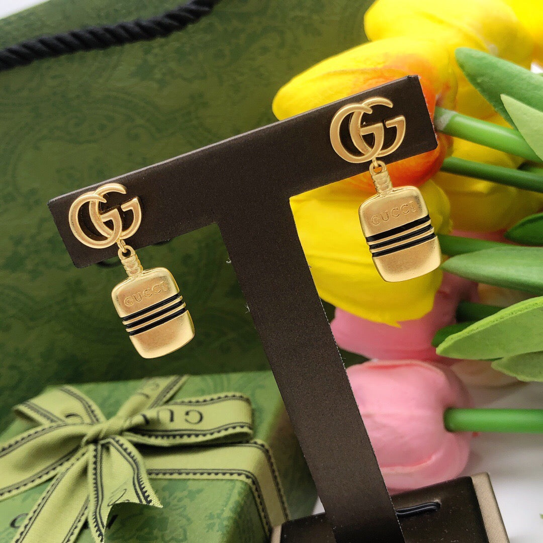 Martin Graham stud earrings in polished metal-tone – styled product view