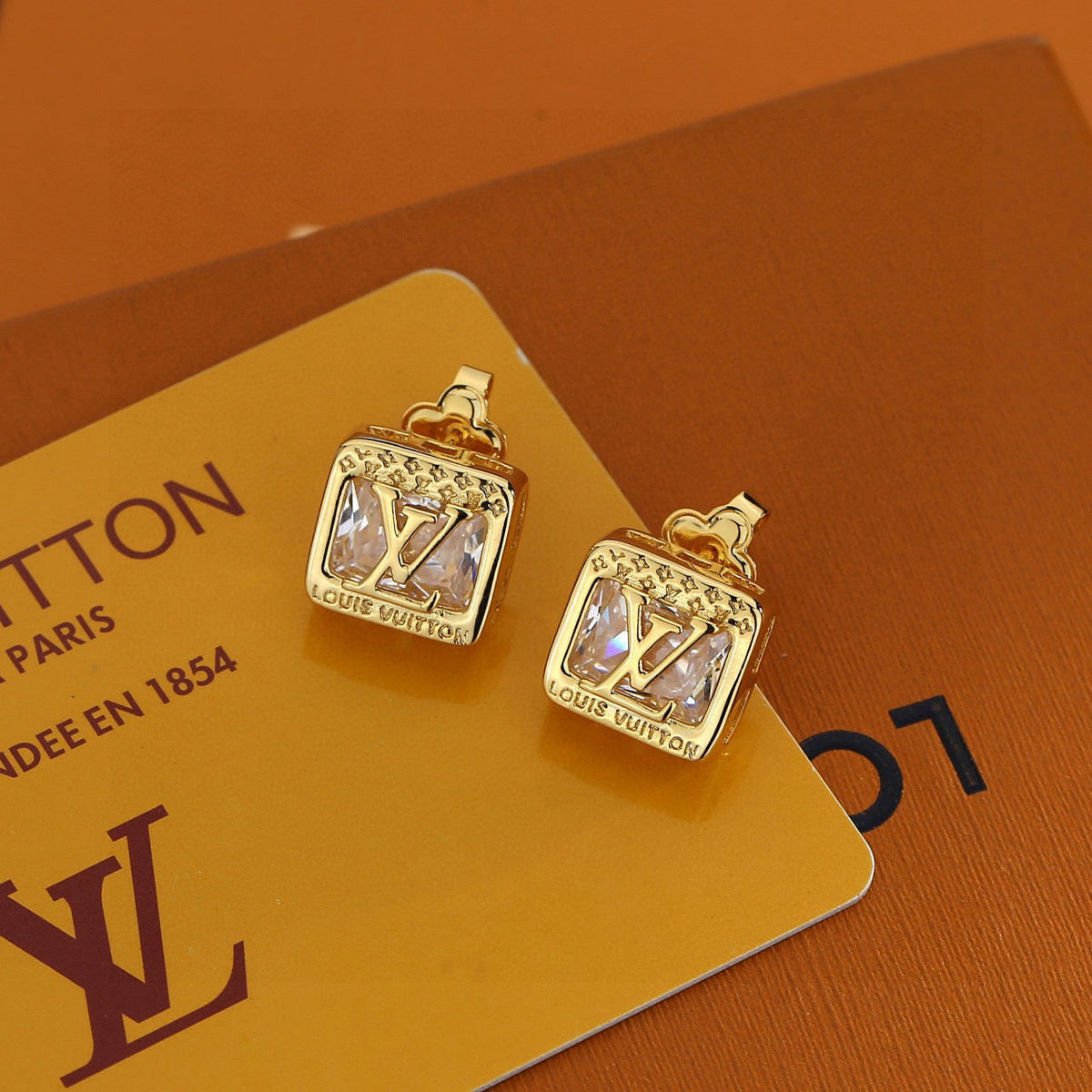Martin Graham stud earrings in polished metal-tone – styled product view