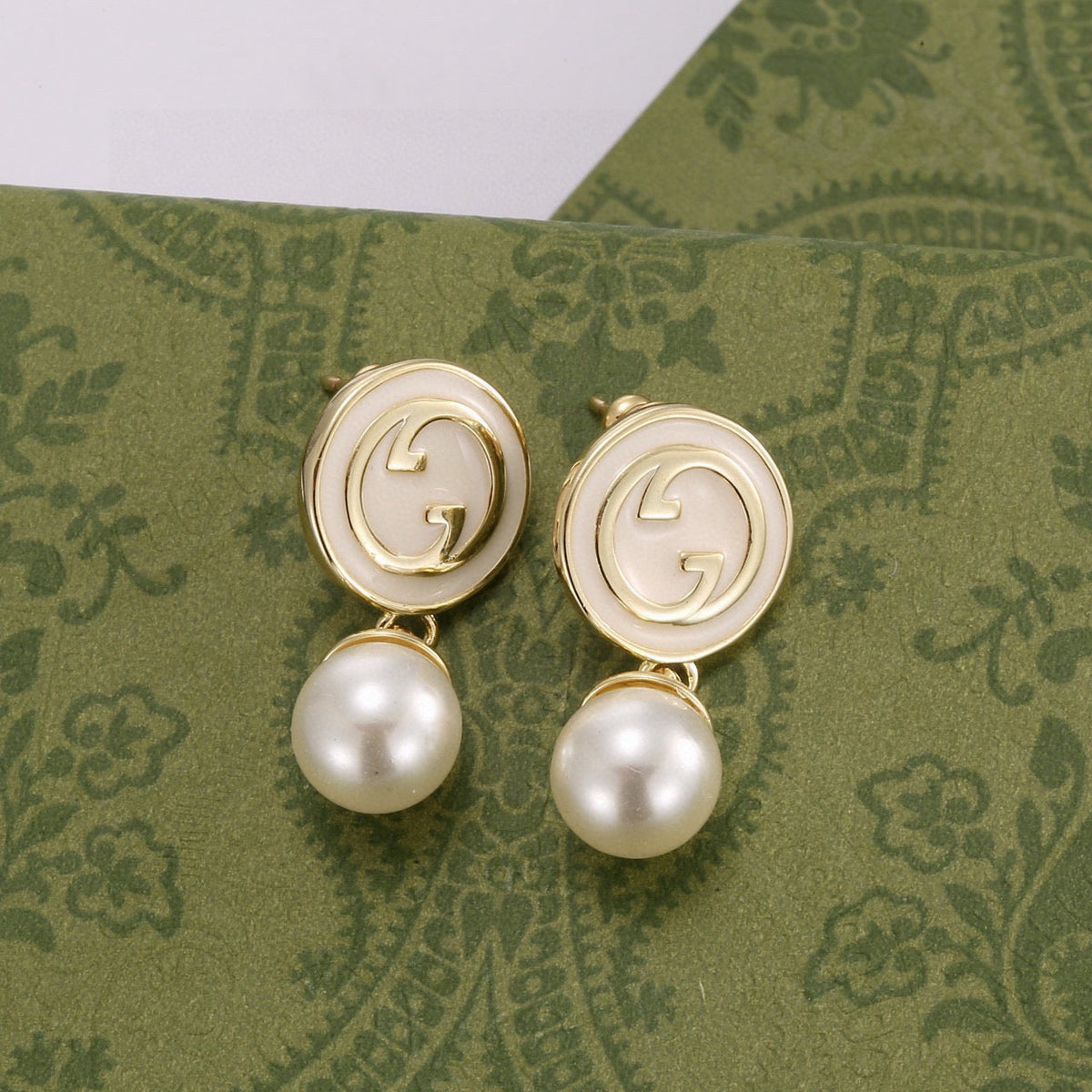 Martin Graham stud earrings in polished metal-tone – front product view