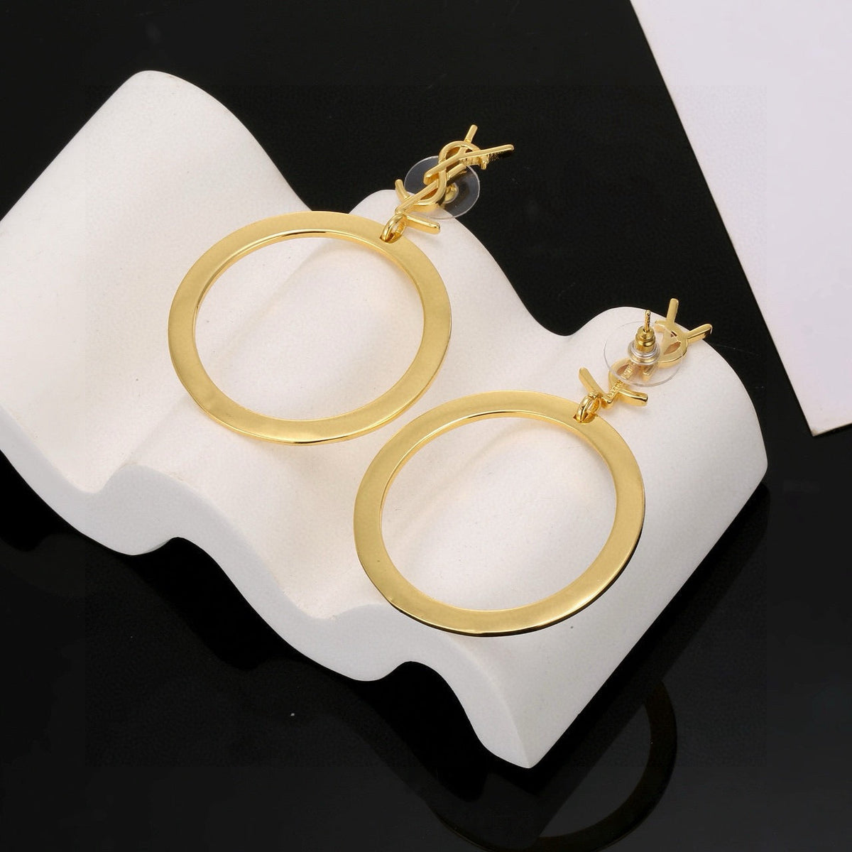 Martin Graham stud earrings in polished metal-tone – detail view