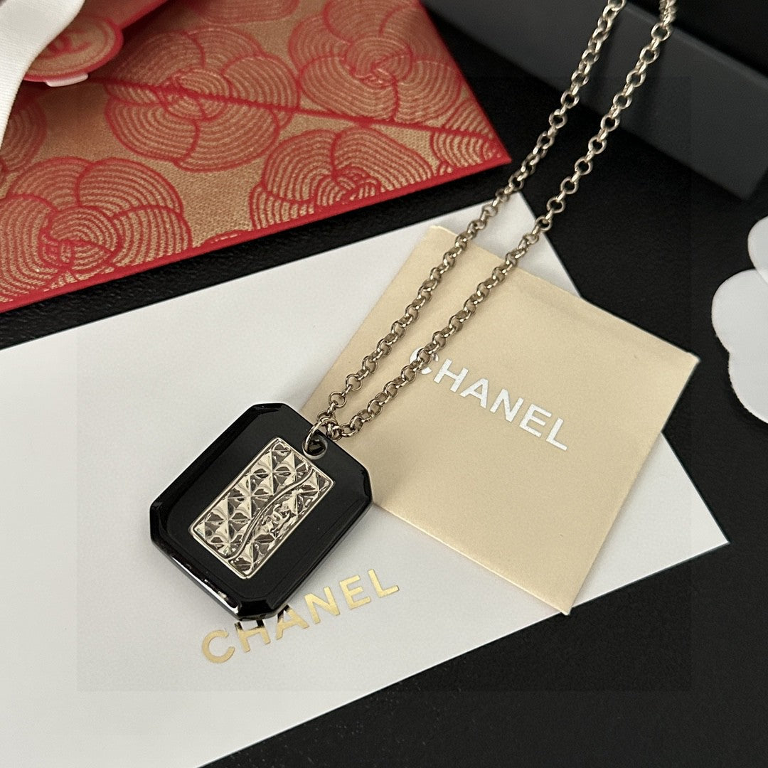 Martin Graham pendant necklace in polished metal-tone – close-up detail