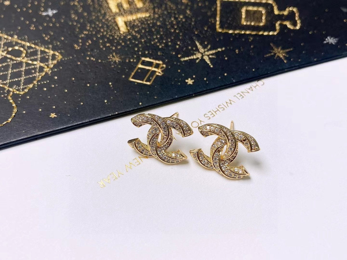 Martin Graham stud earrings in polished metal-tone – close-up detail
