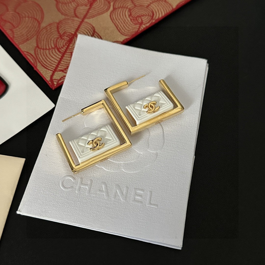 Martin Graham stud earrings in polished metal-tone – close-up detail