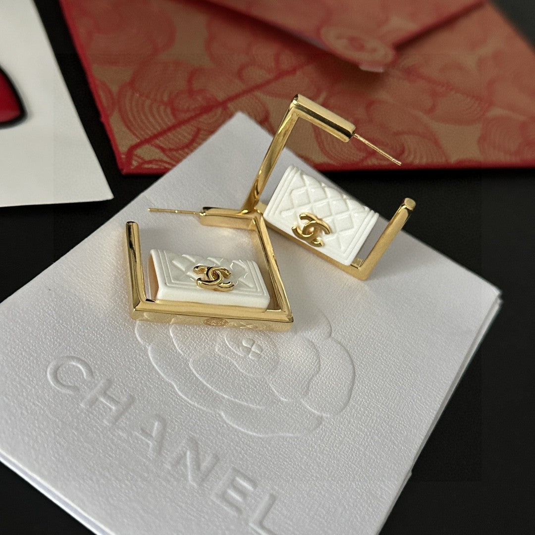 Martin Graham stud earrings in polished metal-tone – detail view
