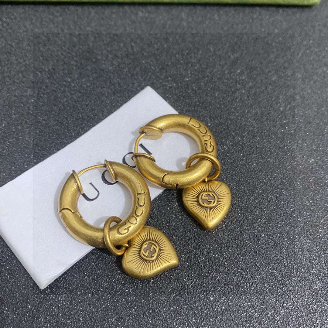 Martin Graham stud earrings in polished metal-tone – detail view