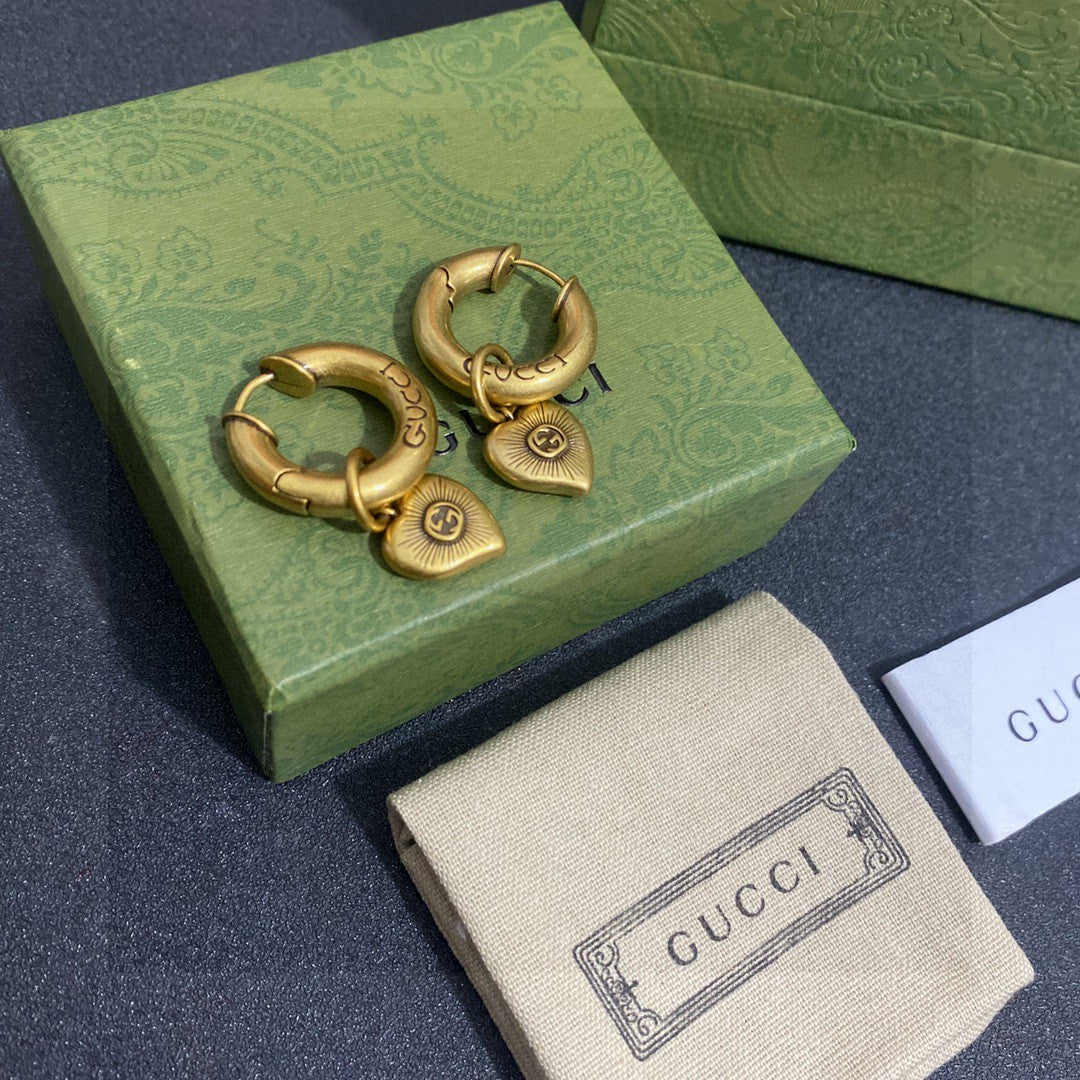 Martin Graham stud earrings in polished metal-tone – close-up detail