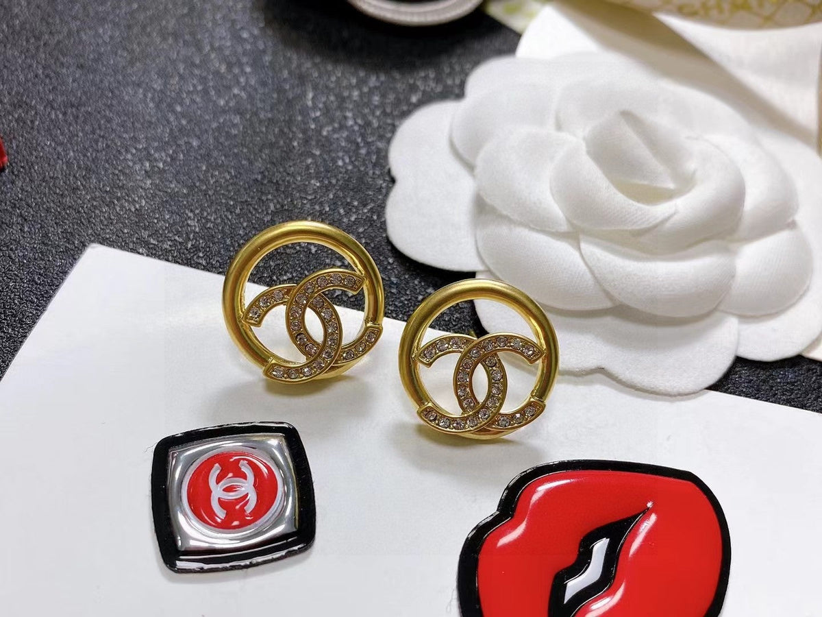 Martin Graham stud earrings in polished metal-tone – styled product view