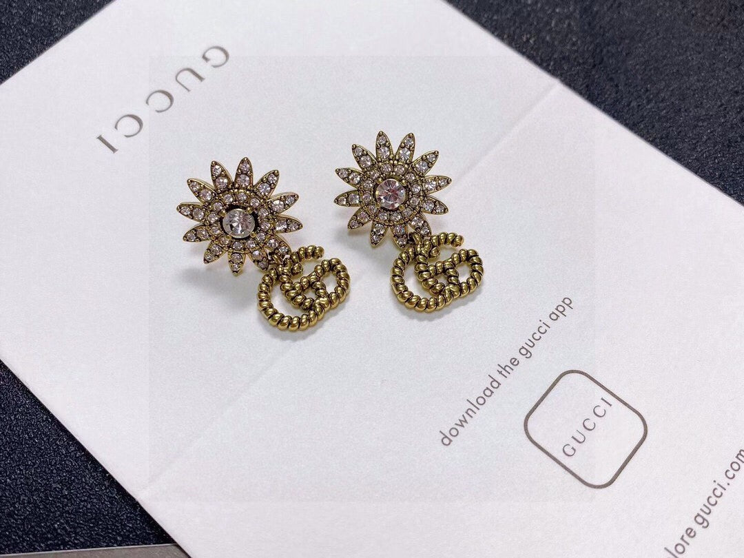 Martin Graham stud earrings in polished metal-tone – close-up detail