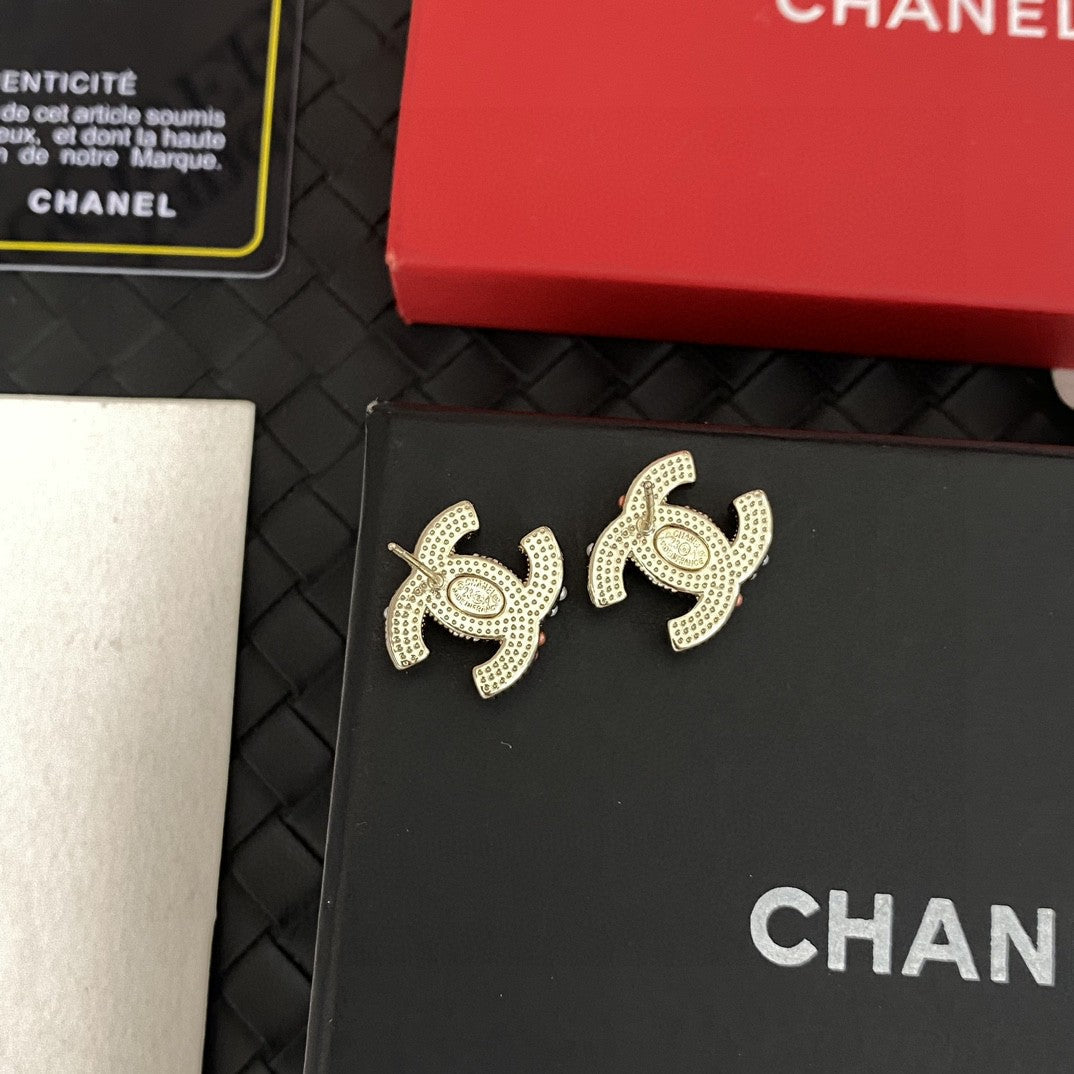 Martin Graham stud earrings in polished metal-tone – close-up detail