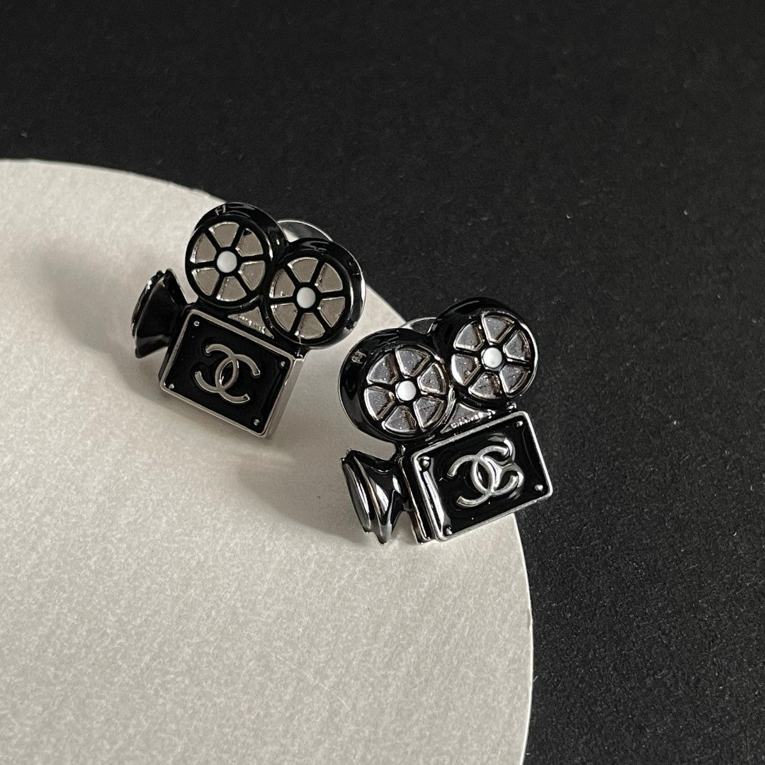 Martin Graham stud earrings in polished metal-tone – close-up detail