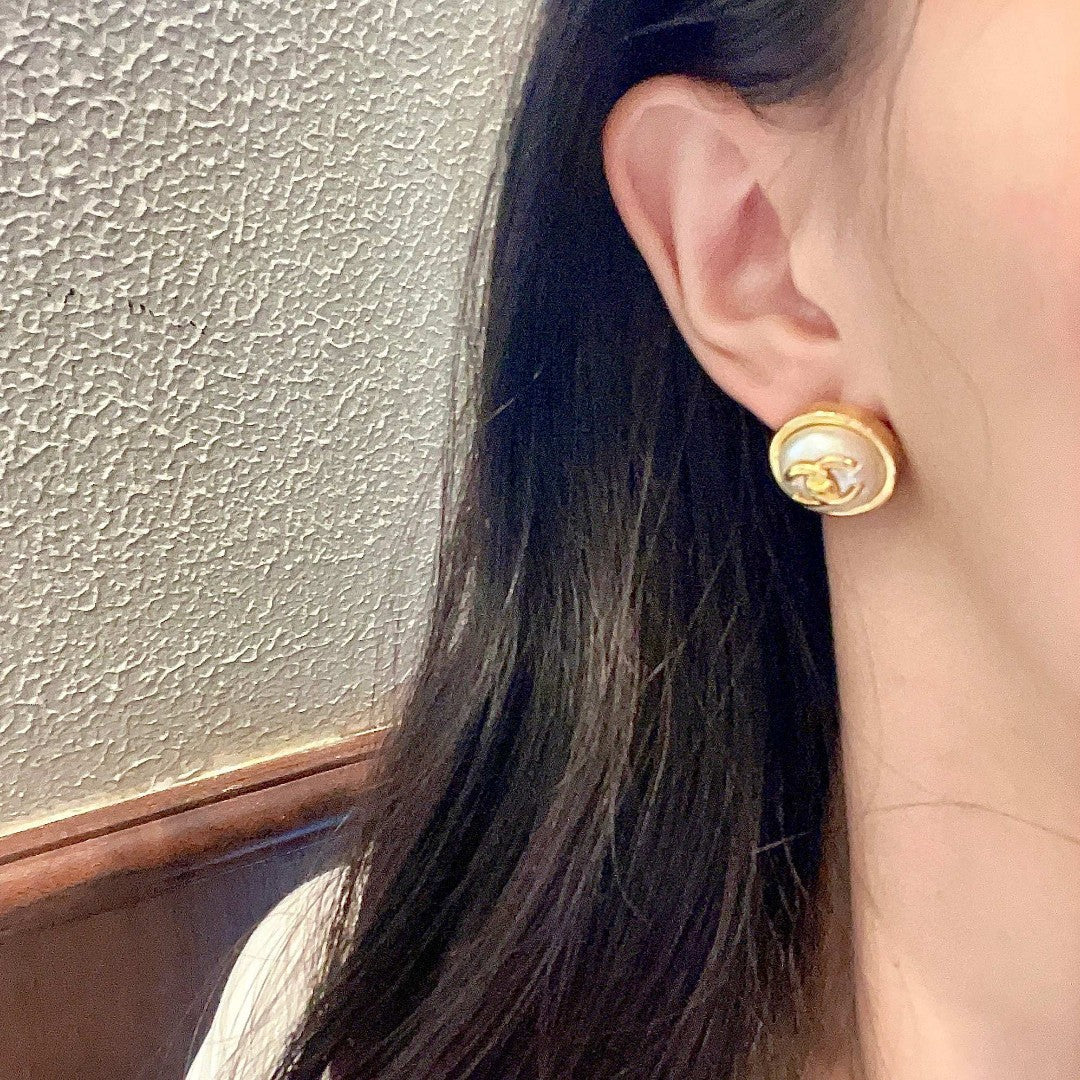Martin Graham stud earrings in polished metal-tone – close-up detail