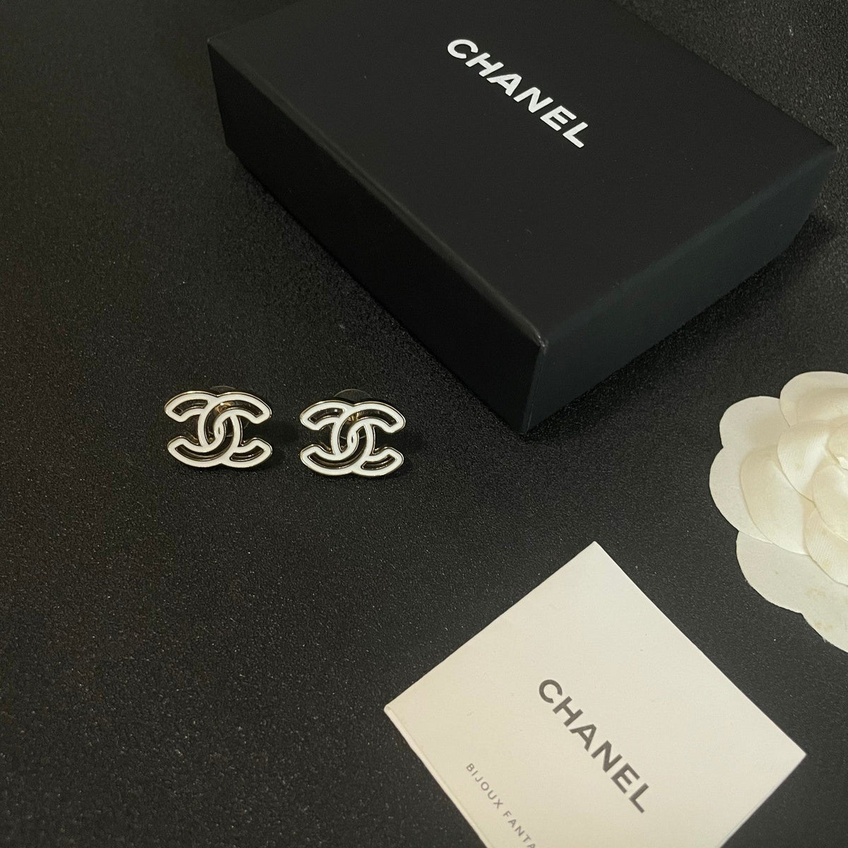 Martin Graham stud earrings in polished metal-tone – close-up detail