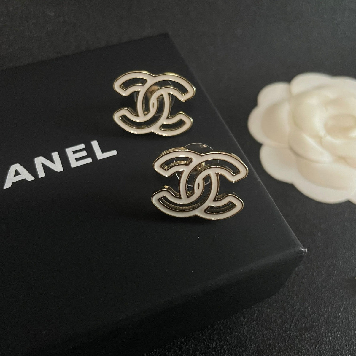 Martin Graham stud earrings in polished metal-tone – detail view