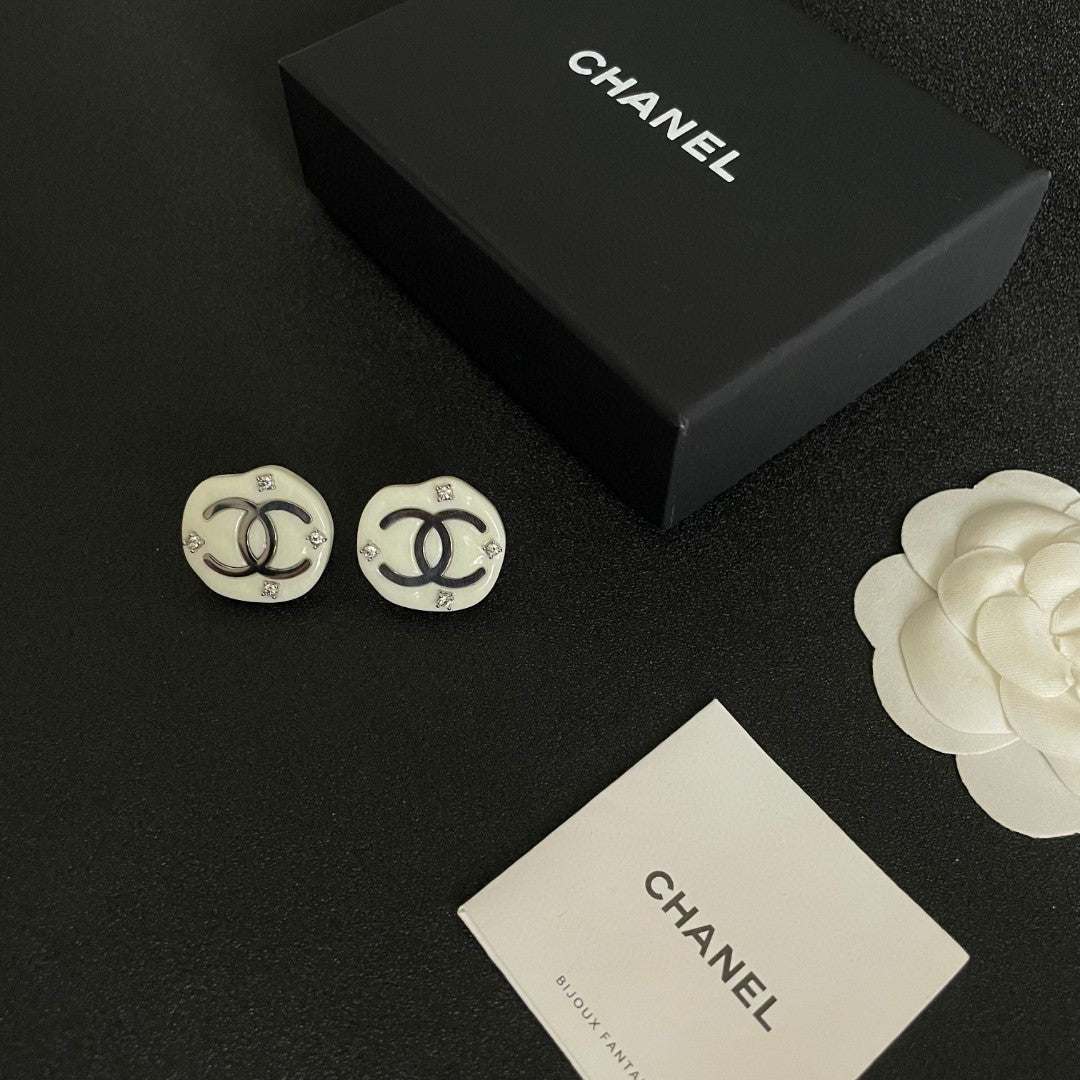 Martin Graham stud earrings in polished metal-tone – close-up detail