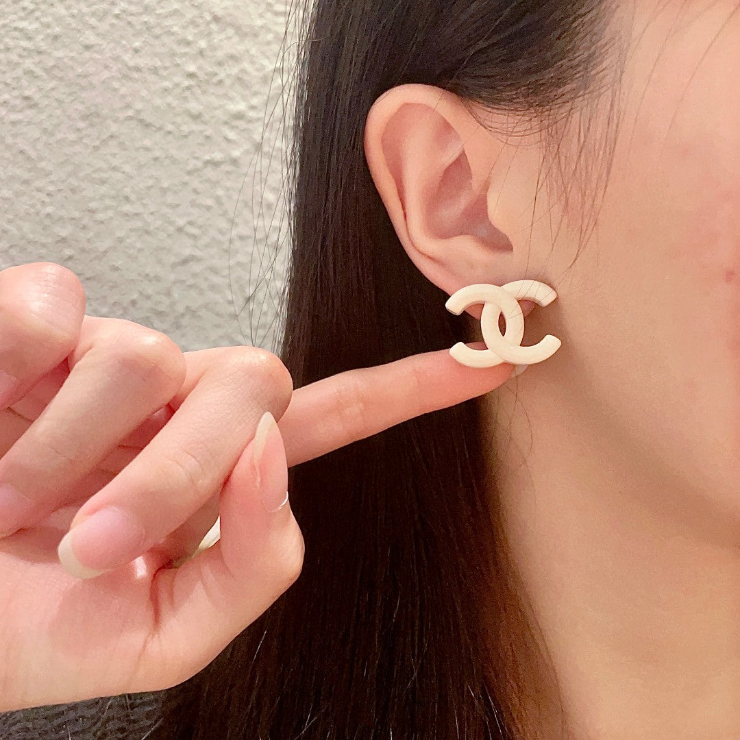 Martin Graham stud earrings in polished metal-tone – front product view
