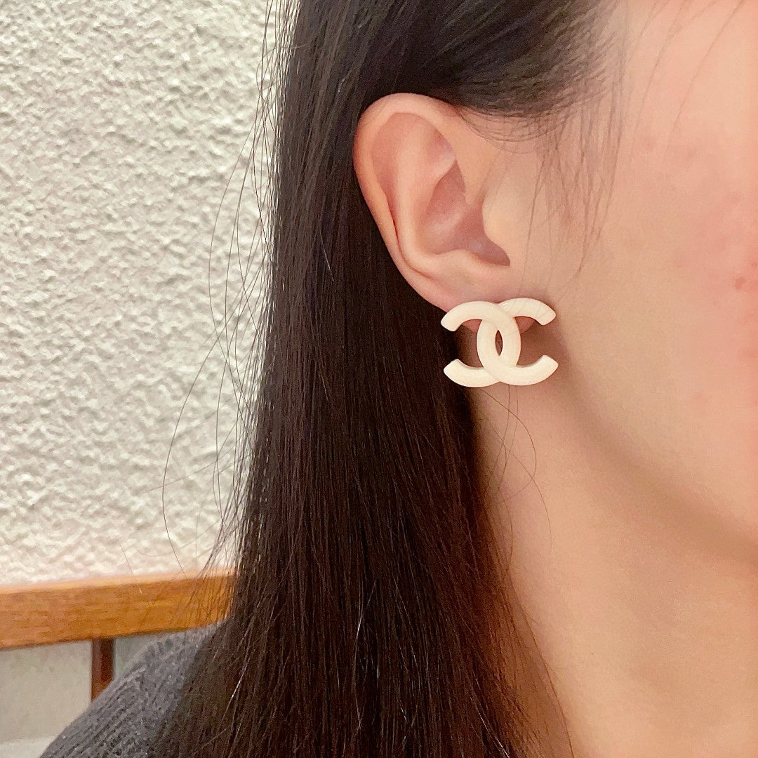 Martin Graham stud earrings in polished metal-tone – detail view