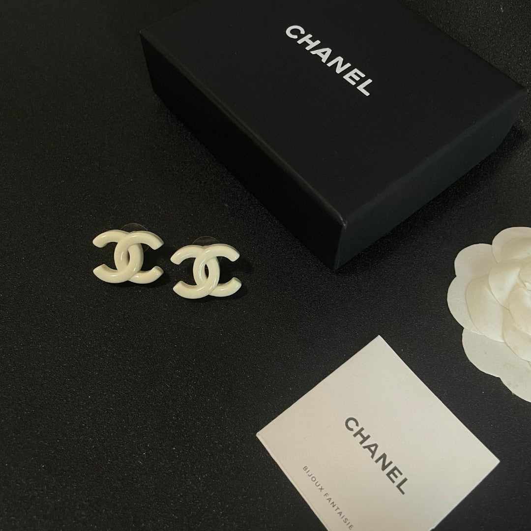 Martin Graham stud earrings in polished metal-tone – close-up detail