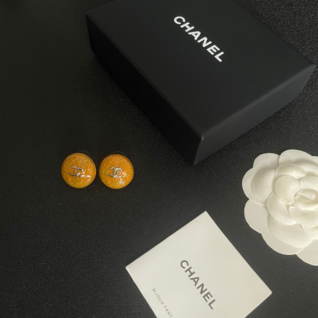 Martin Graham stud earrings in polished metal-tone – close-up detail