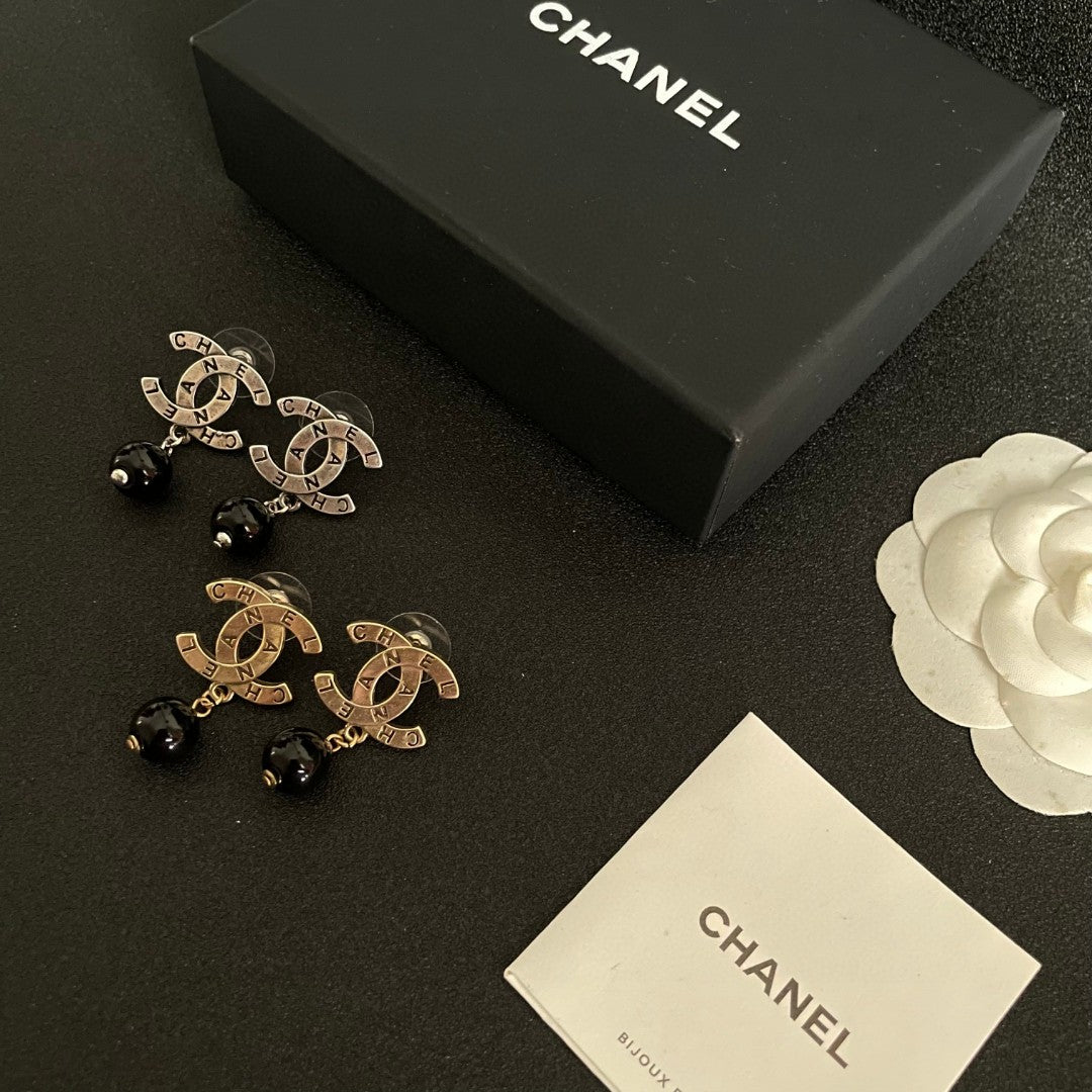 Martin Graham earrings in polished metal-tone – close-up detail