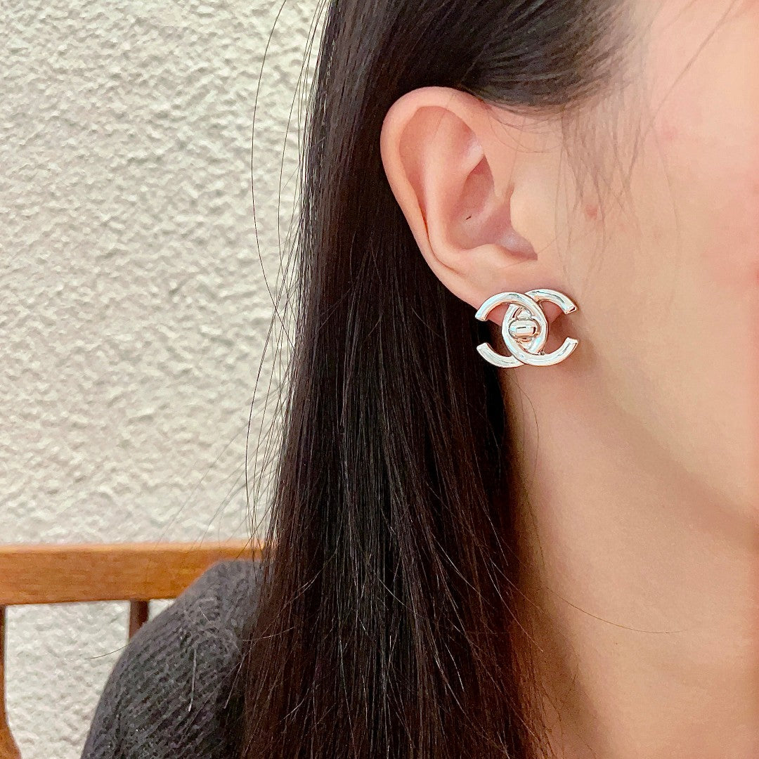 Martin Graham stud earrings in polished metal-tone – detail view