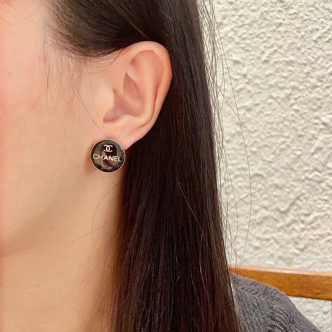 Martin Graham stud earrings in polished metal-tone – detail view