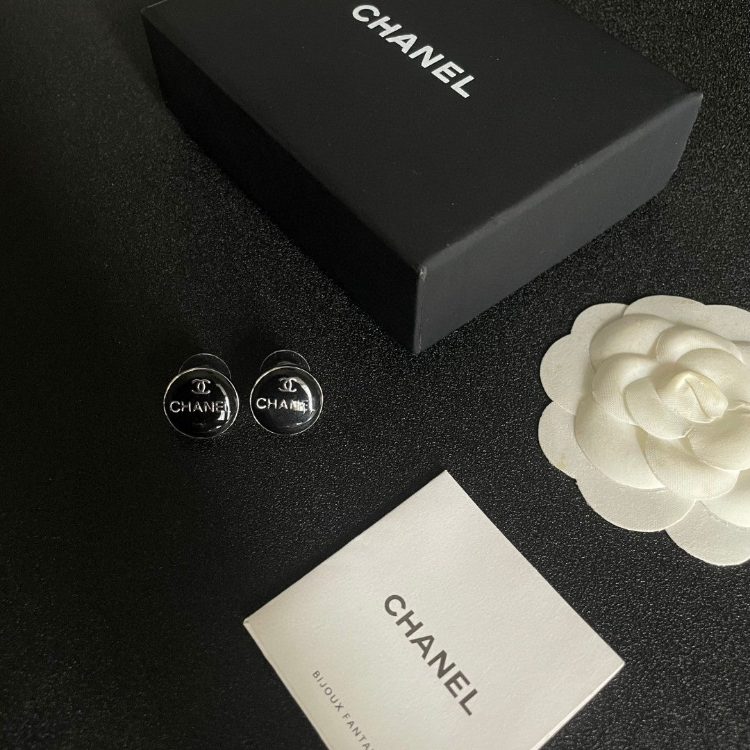 Martin Graham stud earrings in polished metal-tone – close-up detail