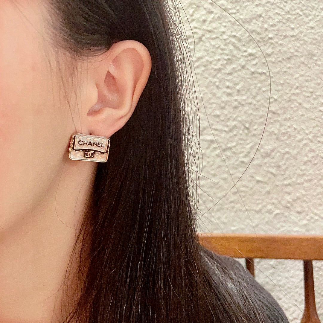 Martin Graham stud earrings in polished metal-tone – detail view
