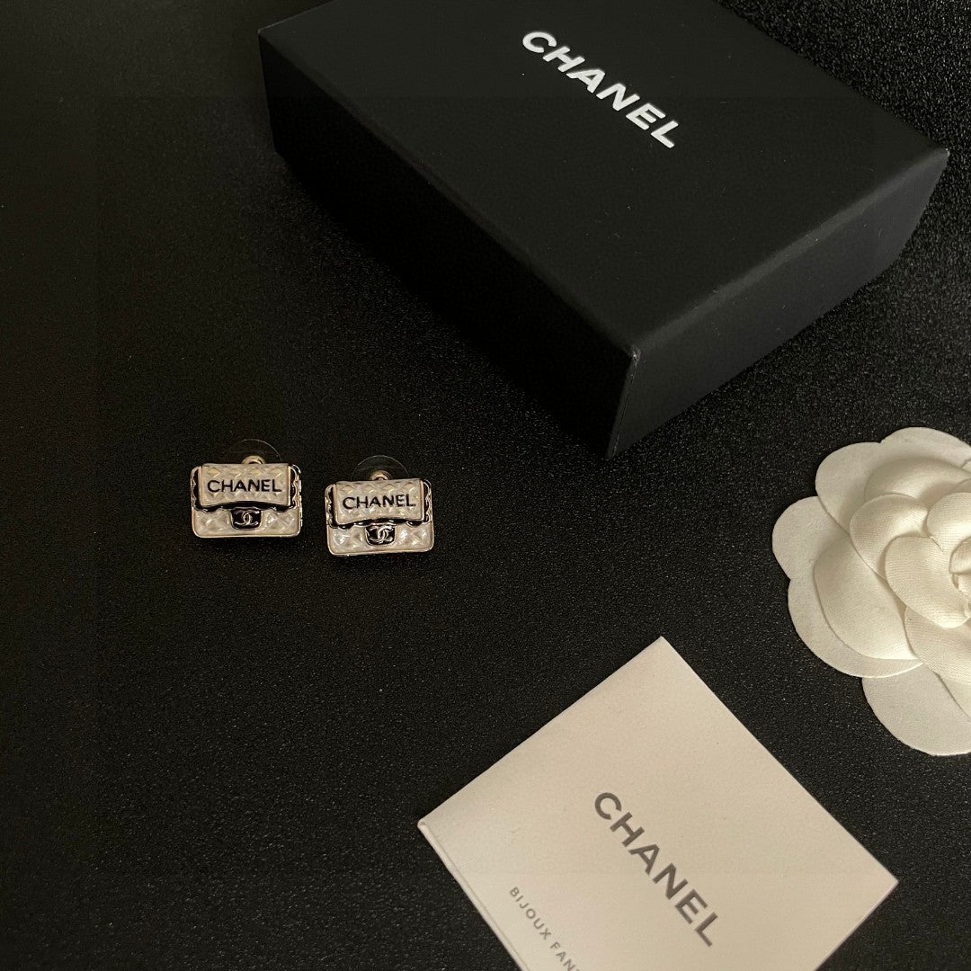 Martin Graham stud earrings in polished metal-tone – close-up detail
