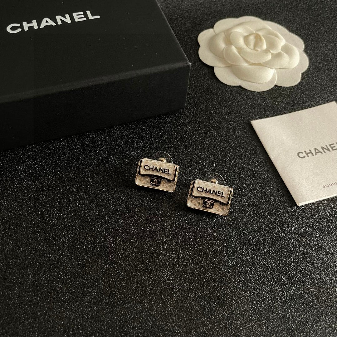 Martin Graham stud earrings in polished metal-tone – styled product view