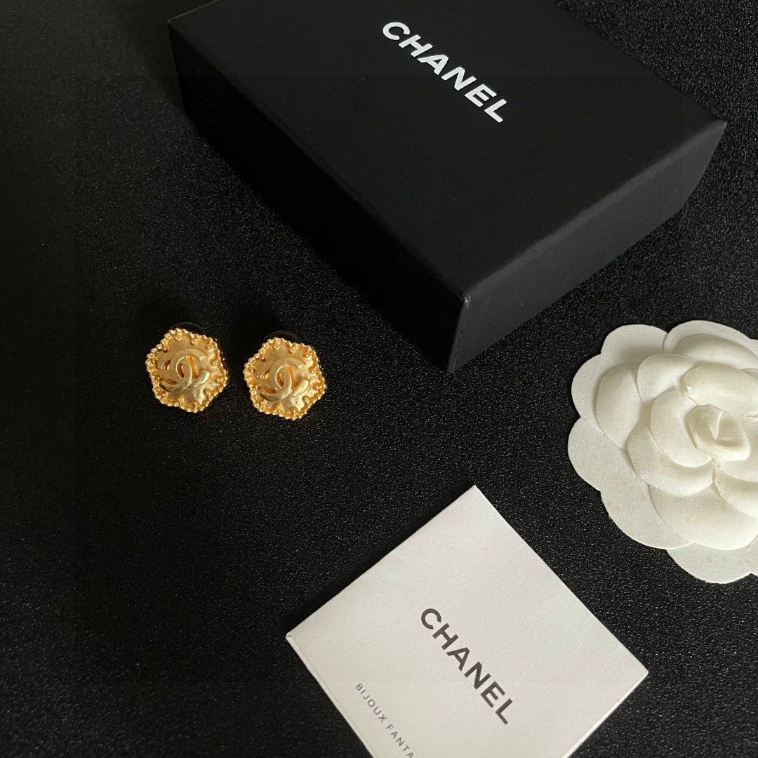 Martin Graham stud earrings in polished metal-tone – close-up detail