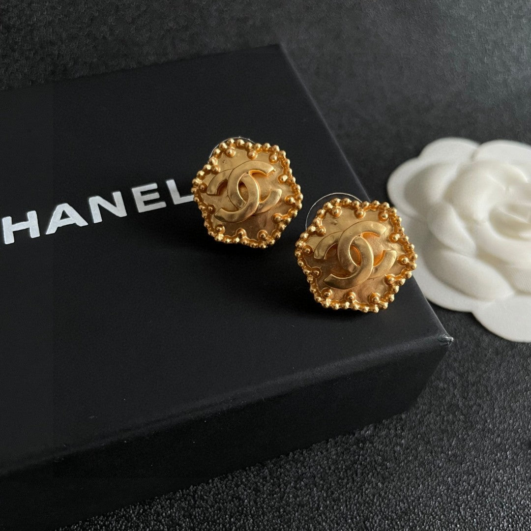 Martin Graham stud earrings in polished metal-tone – detail view