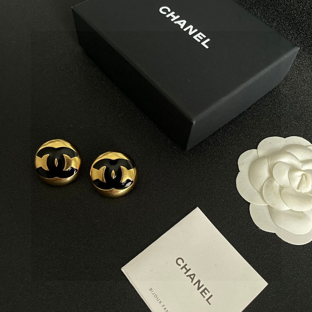 Martin Graham stud earrings in polished metal-tone – close-up detail