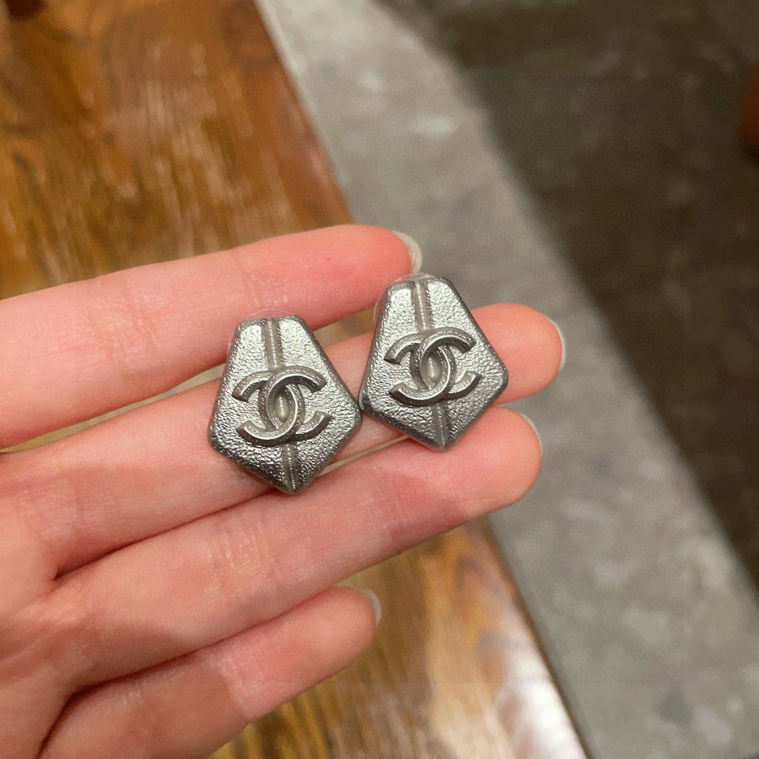 Martin Graham stud earrings in polished metal-tone – side detail