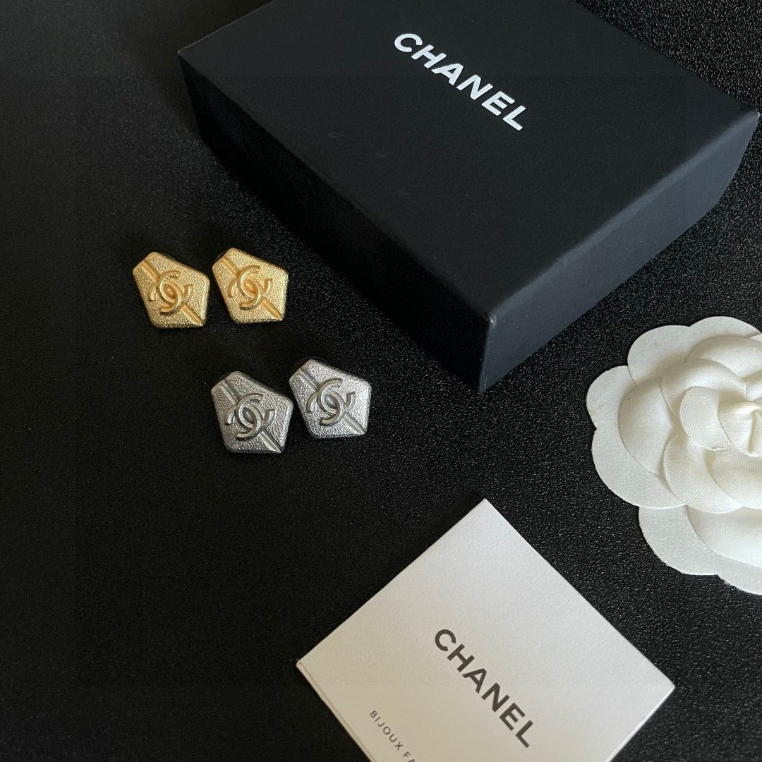 Martin Graham stud earrings in polished metal-tone – close-up detail