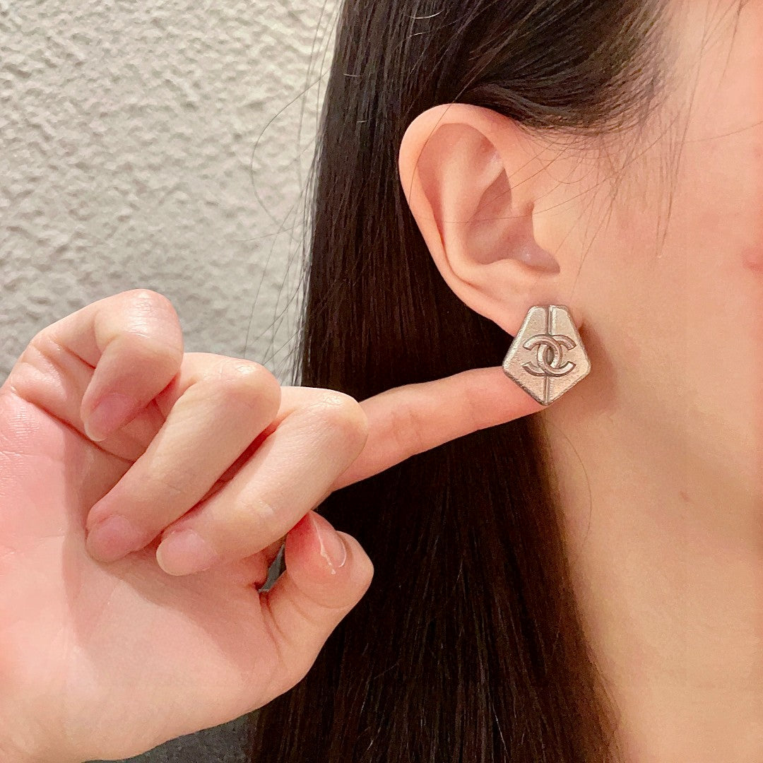 Martin Graham stud earrings in polished metal-tone – front product view