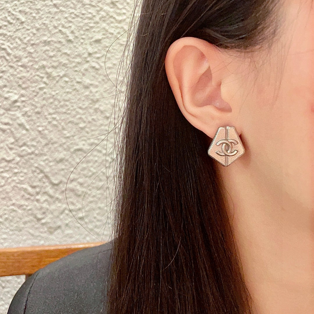 Martin Graham stud earrings in polished metal-tone – detail view