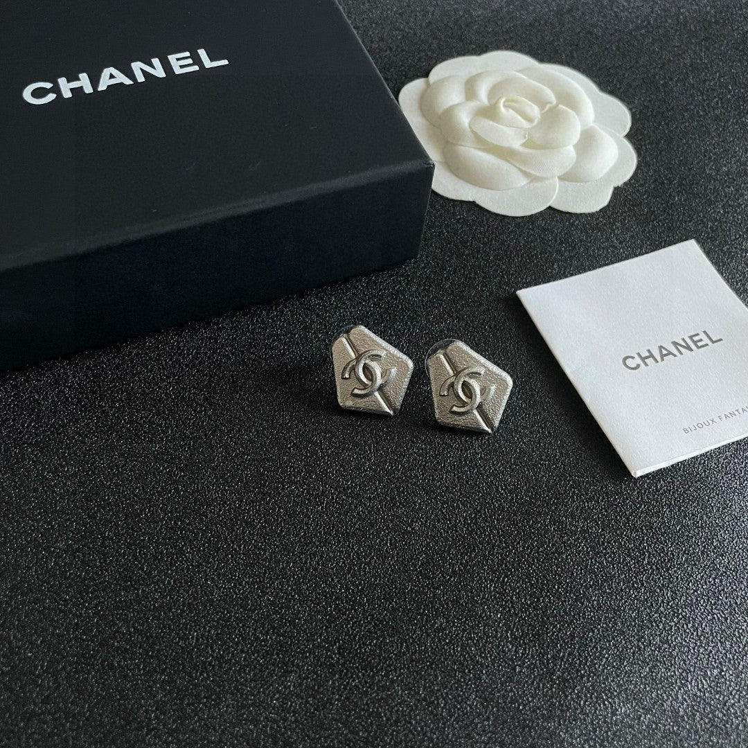 Martin Graham stud earrings in polished metal-tone – styled product view