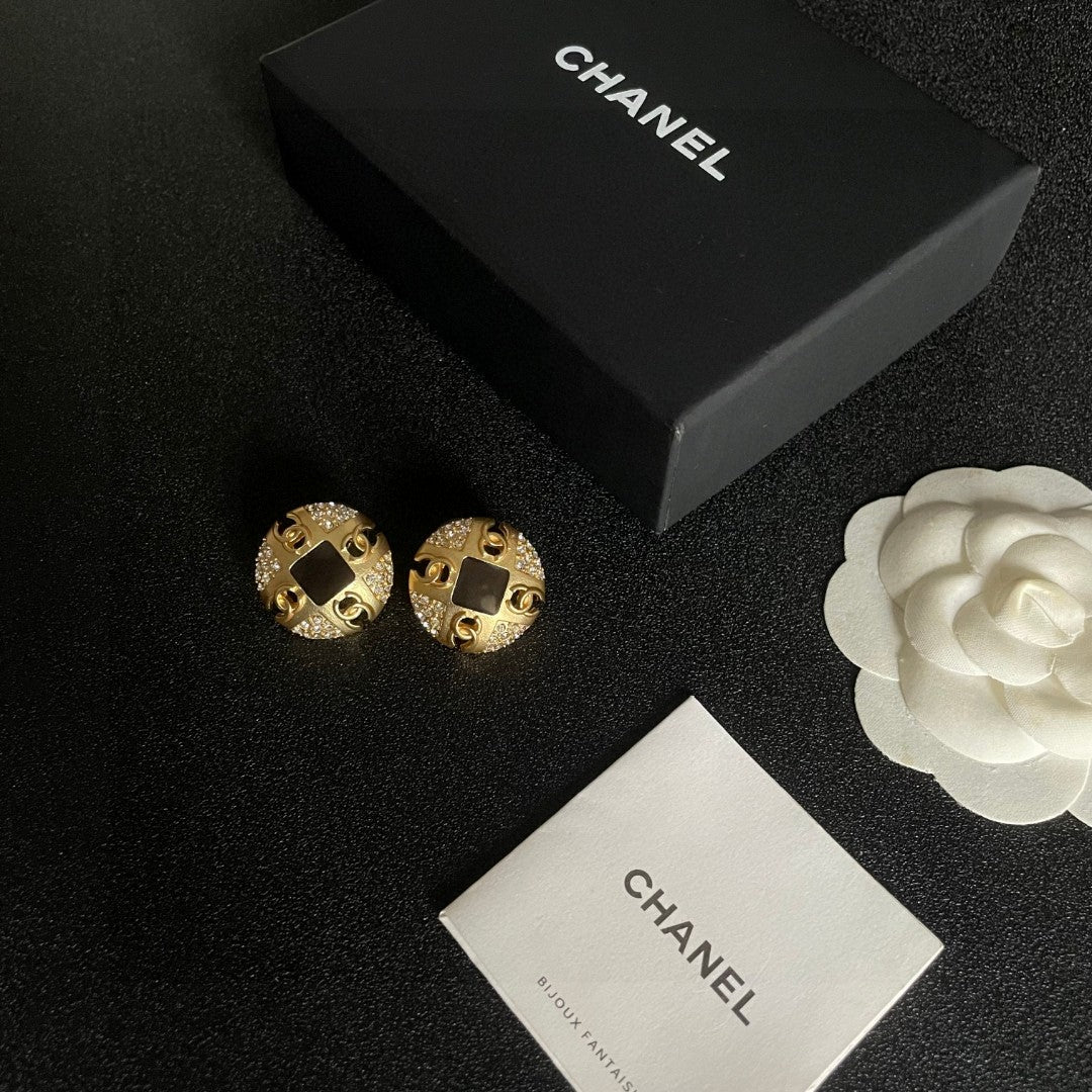 Martin Graham stud earrings in polished metal-tone – close-up detail