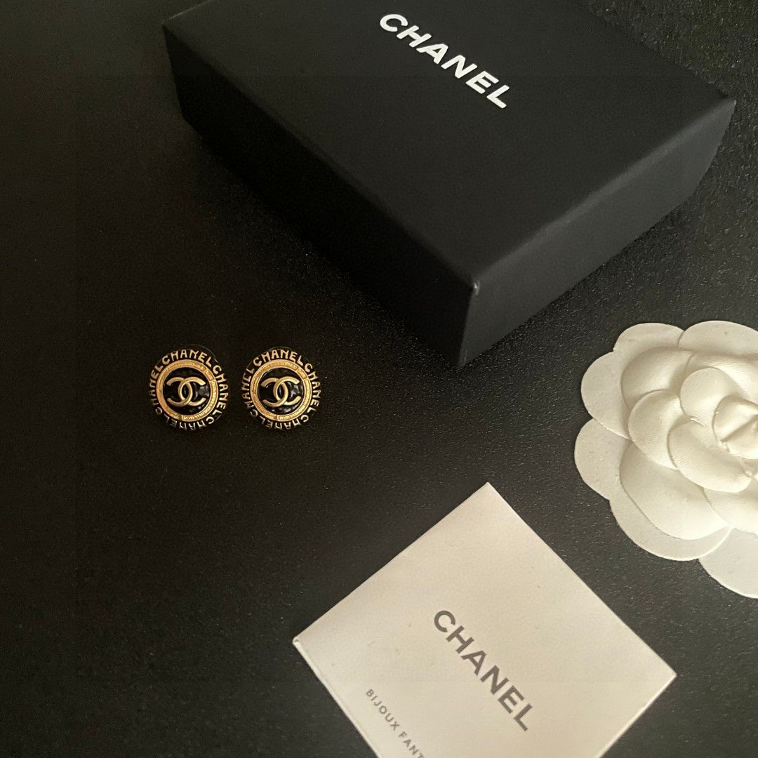 Martin Graham stud earrings in polished metal-tone – close-up detail