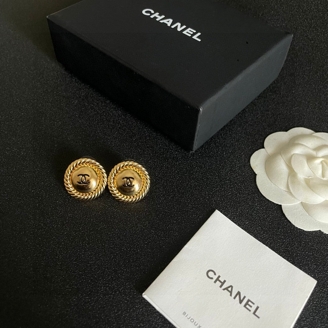 Martin Graham stud earrings in polished metal-tone – close-up detail