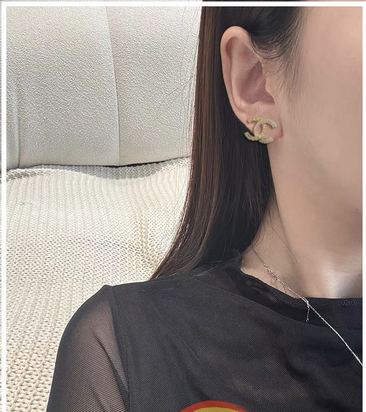 Martin Graham stud earrings in polished metal-tone – front product view