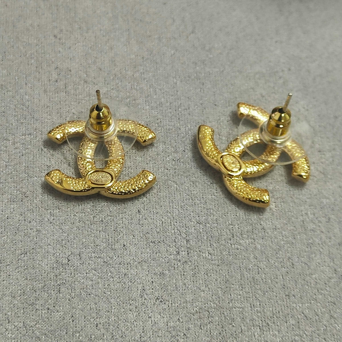 Martin Graham stud earrings in polished metal-tone – close-up detail
