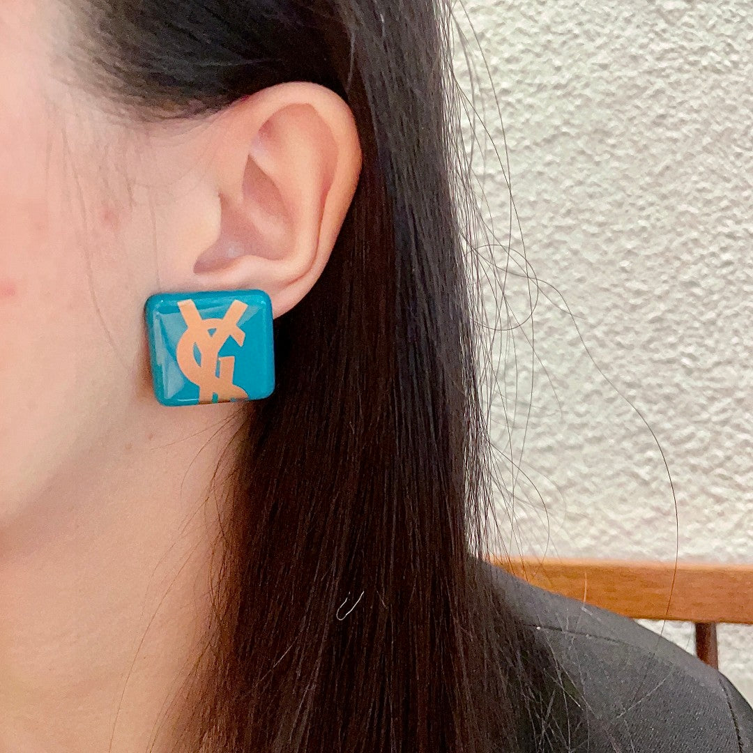 Martin Graham stud earrings in polished metal-tone – detail view